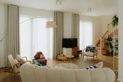 a living room with a white couch and a tv at Boutique Guesthouse - Private Top floor - 3 rooms - host on site available in Ghent