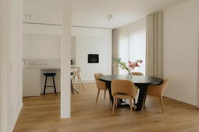 a dining room with a black table and chairs at Boutique Guesthouse - Private Top floor - 3 rooms - host on site available in Ghent