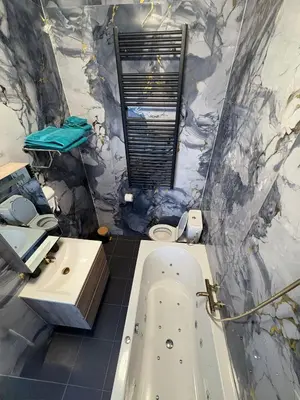a bathroom with a bath tub and a sink at Hôtel Garden's jacuzzi spa 1 in Brussels