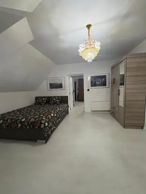 a large bedroom with a bed and a chandelier at Hôtel Garden's jacuzzi spa 1 in Brussels
