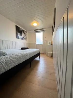 a bedroom with a bed and a bathroom at Studio individuel in Dilbeek