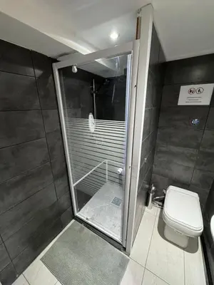 a bathroom with a shower and a toilet at Studio individuel in Dilbeek
