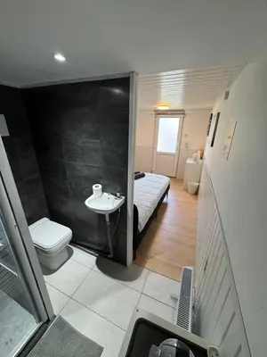 a small bathroom with a toilet and a sink at Studio individuel in Dilbeek