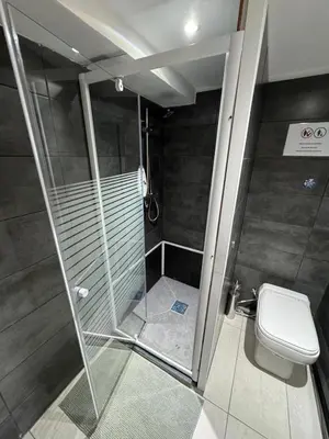 a bathroom with a shower and a toilet at Studio individuel in Dilbeek