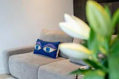 a blue pillow sitting on a couch in a living room at SHWAY - The Second Mate's Glance in Antwerp