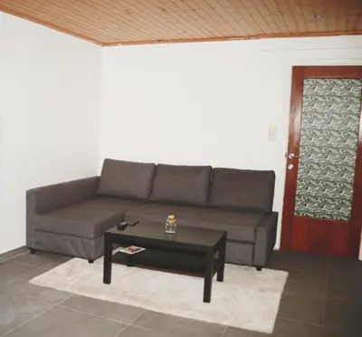 a living room with a couch and a coffee table at Tumaini House in Antwerp