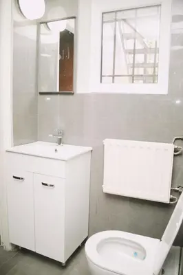 a bathroom with a toilet and a sink and a mirror at Tumaini House in Antwerp