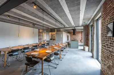 a large dining room with a long table and chairs at Pachthof 1860 in Sint-Pieters-Leeuw
