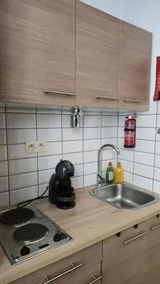 a kitchen counter with a sink and a stove at Royal sleeping Brussels in Brussels