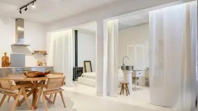 a kitchen and dining room with a table and chairs at Spacious loft near City Centre, Luce CasaMia in Antwerp