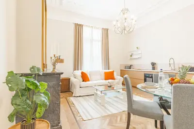 a living room with a table and a couch at Elégance du Quartier Européen Parking gratuit in Brussels