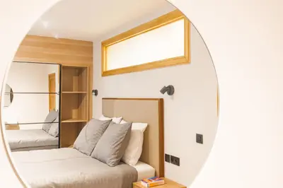 a bedroom with a bed and a mirror at Elégance du Quartier Européen Parking gratuit in Brussels