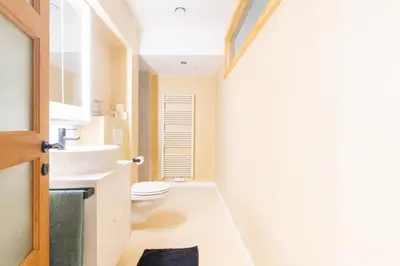 a bathroom with a toilet and a sink at Elégance du Quartier Européen Parking gratuit in Brussels