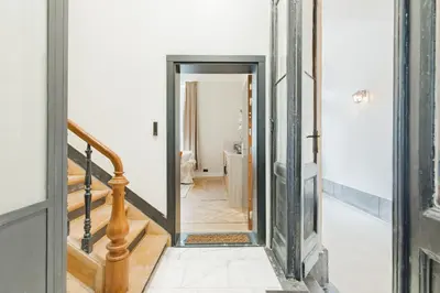 a hallway with a door leading into a room at Elégance du Quartier Européen Parking gratuit in Brussels