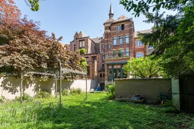 a yard in front of a brick building at Boutique Baron Osy Suite First Terrace in Antwerp