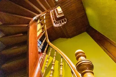 a wooden spiral staircase with a wooden ceiling at Boutique Baron Osy Suite First Terrace in Antwerp