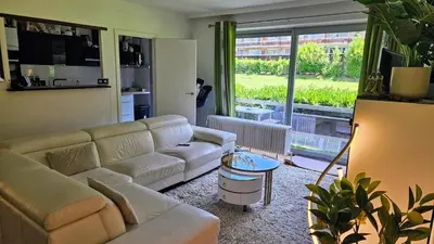 a living room with a couch and a table at Chambre meublée chez l'habitant a uccle in Brussels