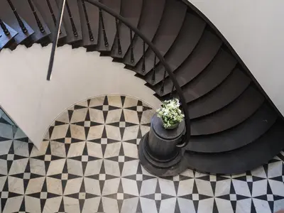 a spiral staircase with a pot with a plant in it at Cosy Studio with Spectacular View from the Rooftop in Ghent