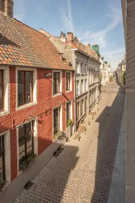 an empty street in a city with buildings at Cosy Studio with Spectacular View from the Rooftop in Ghent