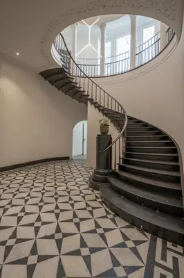 a spiral staircase in a building with a potted plant at Cosy Studio with Spectacular View from the Rooftop in Ghent