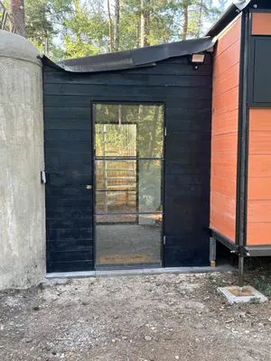 a black house with a window in the side of it at TerraVenturia - Natura Pirsch in Rixensart