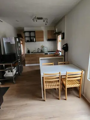 a kitchen with a table and chairs in a room at Chalet Balen in Balen