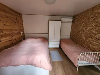 two beds in a room with a wall at Chalet Balen in Balen