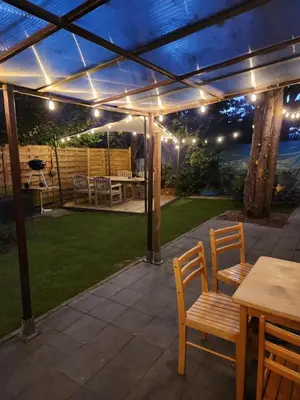 a patio with a table and chairs under a pergola at Chalet Balen in Balen