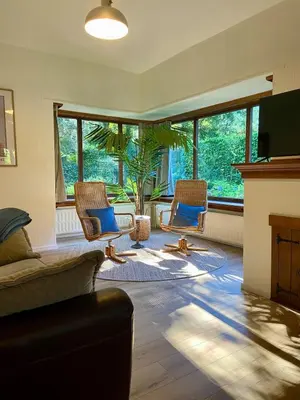 a living room with two chairs and a fireplace at Romantic BNB, Castle-Nature Walks, Sauna, Garden in Schilde