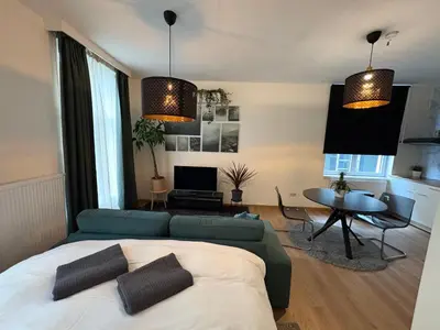 a living room with a couch and a table at Center monet in Ghent