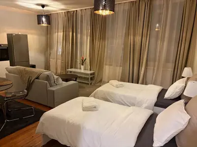 a hotel room with two beds and a chair at Center monet in Ghent