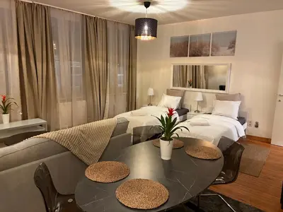 a living room with two beds and a table and a couch at Center monet in Ghent