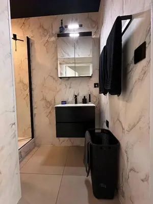 a bathroom with a sink and a mirror at Cozy Family Apartment - Bus & Tram Right in Front in Antwerp