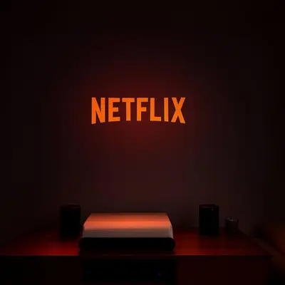 a netflix sign on a wall next to a bench at Cozy Family Apartment - Bus & Tram Right in Front in Antwerp