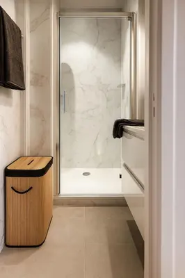 a bathroom with a shower with a glass door at Cozy & Relaxing Apartment - Bus & Tram at Door in Antwerp