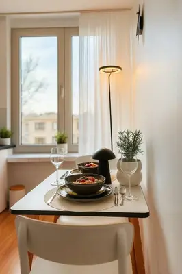a table with a plate of food and a window at Cozy & Relaxing Apartment - Bus & Tram at Door in Antwerp