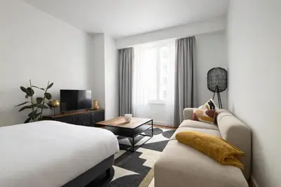 a hotel room with a bed and a couch at Cozy & Relaxing Apartment - Bus & Tram at Door in Antwerp