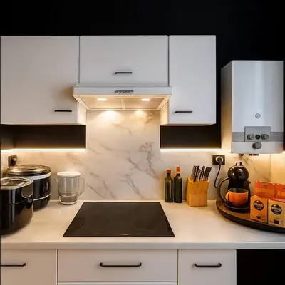 a kitchen with white cabinets and a stove top at Cozy & Relaxing Apartment - Bus & Tram at Door in Antwerp