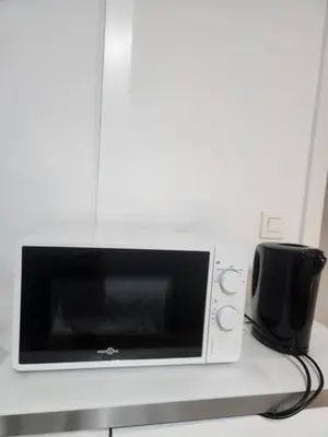 a microwave oven sitting on top of a counter at Mila's Cosy Place in Boortmeerbeek