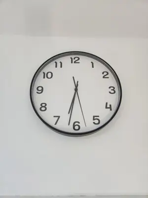 a clock hanging on a white wall at Mila's Cosy Place in Boortmeerbeek