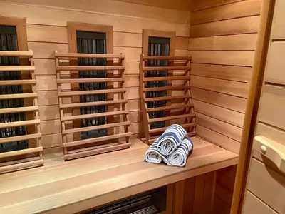 a sauna with towels sitting on a wooden shelf at Romantic Loft, historic farmhouse, Sauna, Nature walks in Schilde