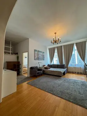 a large living room with a bed and a couch at The Louise Residence in Brussels