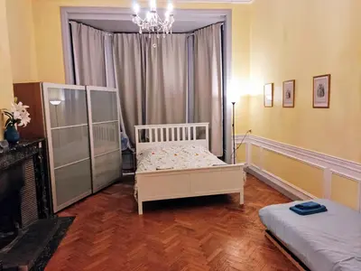 a bedroom with a bed and a chandelier at Bright 1BR with terrace near Montgomery in Brussels