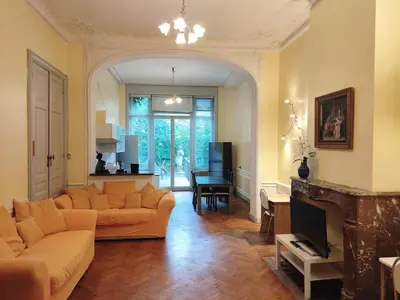 a living room with a couch and a fireplace at Bright 1BR with terrace near Montgomery in Brussels