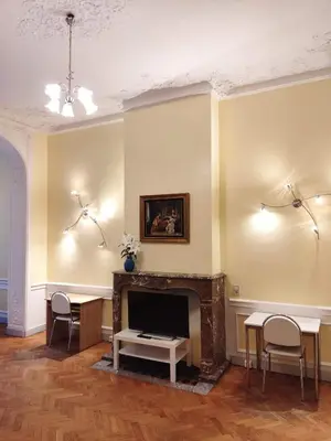 a living room with a fireplace and chairs at Bright 1BR with terrace near Montgomery in Brussels