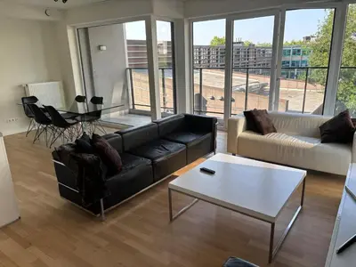 a living room with a couch and a coffee table at Modern City Apartment Close to Everything in Brussels