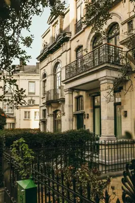 a building with balconies and a fence in front of it at La Villa Maurice in Brussels