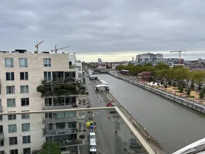 a view of a river in a city with a building at Top floor luxury with spectacular water views in Brussels
