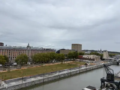 a view of a city with a river and buildings at Top floor luxury with spectacular water views in Brussels
