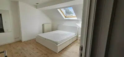 a small bedroom with a bed in a attic at Wonderful Brussels in Uccle in Brussels